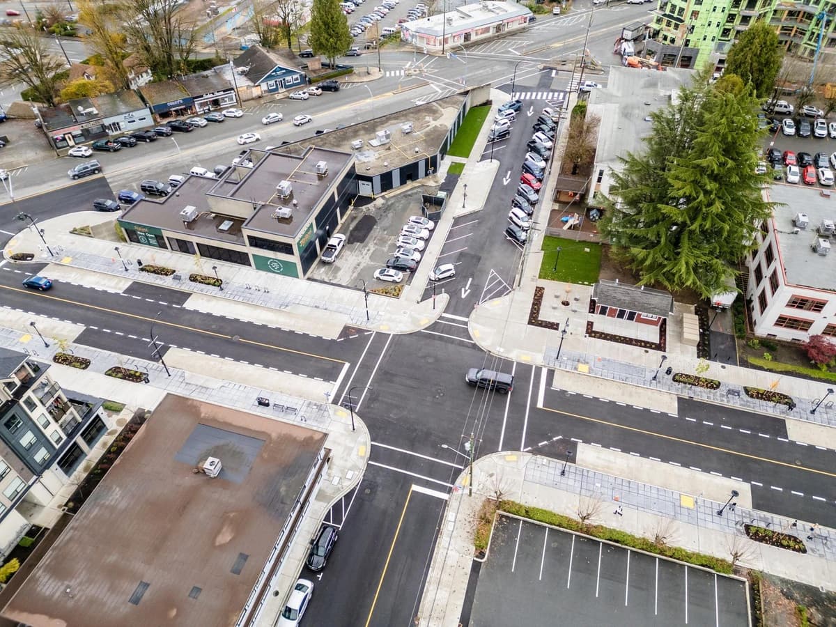 An excavator digging and moving soil on a construction site.